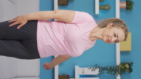 Vertical-video-of-Woman-doing-arm-exercises-at-home.-Fitness,-sport.